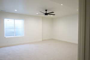 Spare room featuring ceiling fan, light carpet, baseboards, visible vents, and recessed lighting
