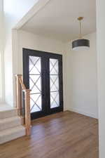 Entryway with baseboards, wood finished floors, and plenty of natural light