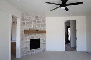 Unfurnished living room with baseboards, a ceiling fan, a fireplace, recessed lighting, and carpet flooring