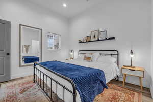Bedroom featuring wood finished floors, baseboards, and recessed lighting