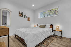 Bedroom featuring baseboards, recessed lighting, and wood finished floors