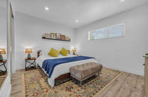 Bedroom with recessed lighting, light wood-style floors, and baseboards