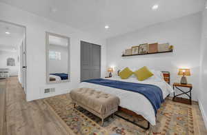 Bedroom featuring visible vents, baseboards, recessed lighting, and wood finished floors