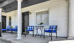 Exterior space with a porch and brick siding
