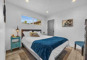 Bedroom featuring light wood-style flooring, recessed lighting, and baseboards