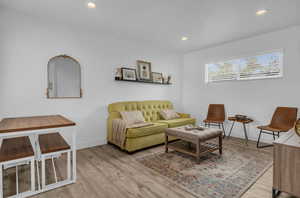 Living room featuring baseboards, recessed lighting, and wood finished floors