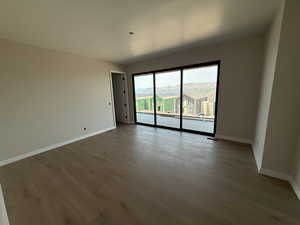 Primary bedroom with wood finished floors and private deck.
