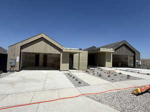 View of front of property featuring a garage and driveway
