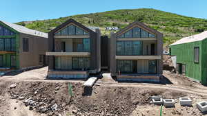Back of property with a mountain view