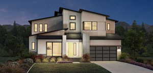 Modern home featuring an attached garage, driveway, and stucco siding