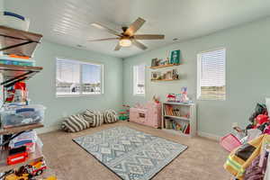 Game room featuring visible vents, ceiling fan, and a healthy amount of sunlight