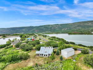 Birds eye view of property featuring a water and mountain view