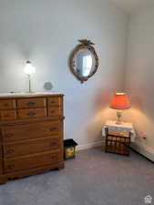 Living area with baseboards and carpet floors