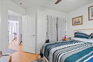 Bedroom with a ceiling fan and wood finished floors