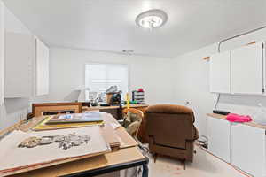 Office area featuring concrete flooring and visible vents