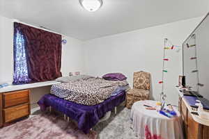 Bedroom featuring visible vents and carpet floors
