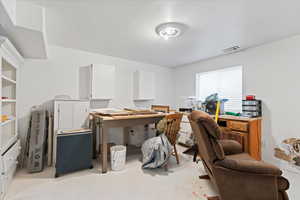 Office space featuring concrete flooring and visible vents