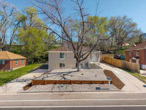 View of front of house with driveway and a fenced front yard