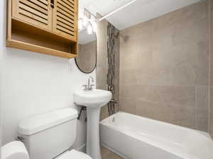 Full bath featuring bathing tub / shower combination and toilet