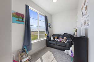 Living area with baseboards and carpet floors