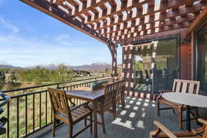 Balcony featuring a mountain view and a pergola