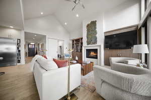 Living area featuring high vaulted ceiling, Fireplace ceiling fan, and recessed lighting