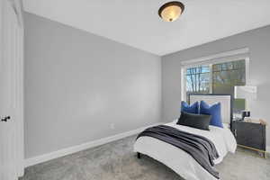 Bedroom featuring carpet flooring and baseboards