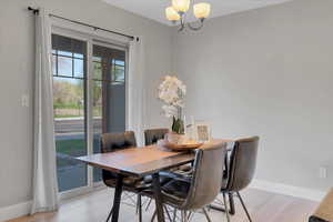 Dining room with a chandelier and baseboards
