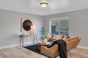 Living area with baseboards and wood finished floors