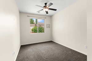 Carpeted spare room featuring ceiling fan, baseboards, and visible vents