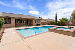 View of pool featuring a fenced in pool, a patio area, a fenced backyard, and an in ground hot tub