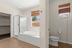 Bathroom with a bath, baseboards, toilet, a shower stall, and tile patterned flooring