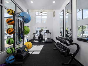 Workout area with a ceiling fan, recessed lighting, and a healthy amount of sunlight
