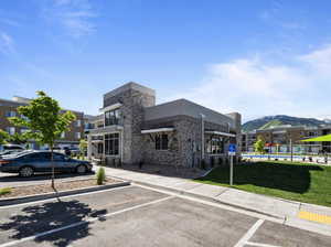View of building exterior featuring uncovered parking and a mountain view