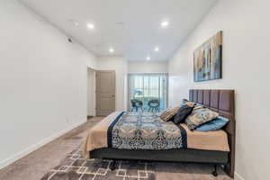 Carpeted bedroom featuring recessed lighting, visible vents, and baseboards