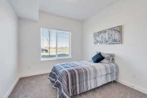 Carpeted bedroom featuring baseboards