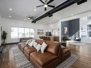 Living room with wood finished floors, a ceiling fan, plenty of natural light, and recessed lighting
