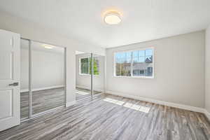 Primary bedroom with brand new floors, paint, lighting, and double closets.