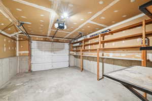 Garage with a brand new door, new opener and storage.