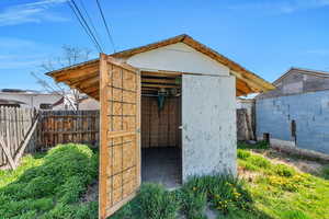 View of shed with fence