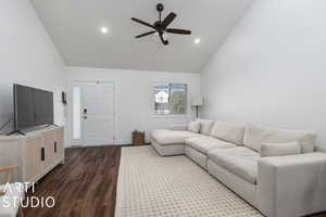 Living area with ceiling fan, high vaulted ceiling, recessed lighting, and dark wood finished floors