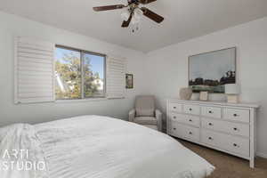 Bedroom featuring dark carpet and ceiling fan