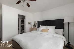 Carpeted bedroom with a ceiling fan