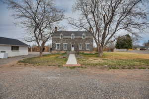 View of front of property with fence and a chimney