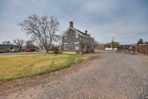 Exterior space with fence, a yard, and a chimney