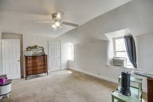 Additional living space featuring carpet, baseboards, a ceiling fan, and vaulted ceiling