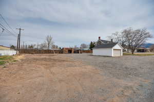 View of yard featuring fence and an outdoor structure