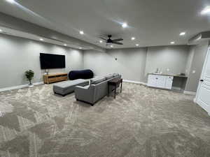 Living area with wet bar, a ceiling fan, light carpet, and recessed lighting