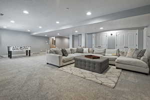 Living area featuring visible vents, baseboards, recessed lighting, and carpet