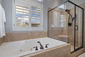 Full bath featuring a shower stall and a garden tub